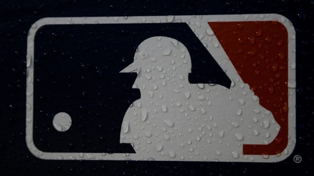 A rain-covered logo is seen at Fenway Park before Game 1 of the World Series baseball game between the Boston Red Sox and the Los Angeles Dodgers Tuesday, Oct. 23, 2018, in Boston. The mood for Major League Baseball fans is a little glum these days as the players' union and owners continue to bicker over finances. The owners locked out the players on Dec. 2 and unless an agreement between the two sides is reached soon, the spring training schedule is in trouble. The first games are slated for Feb. 26, 2022.