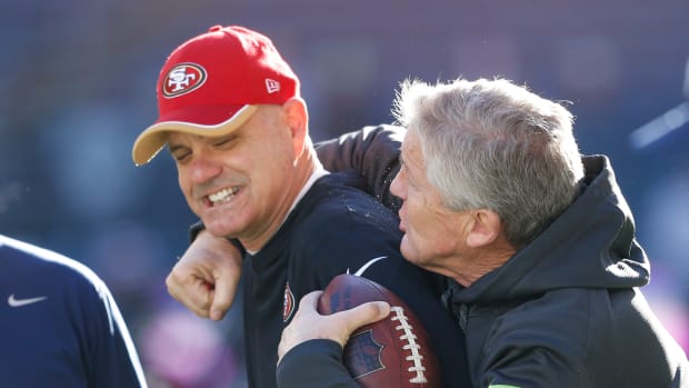 NFL: San Francisco 49ers at Seattle Seahawks Dec 14, 2014; Seattle, WA, USA; Seattle Seahawks head coach Pete Carroll (right) greets San Francisco 49ers secondary coach Ed Donatell during pre game warmups at CenturyLink Field