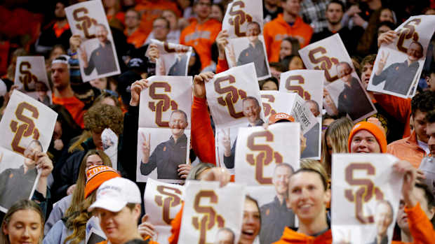 Oklahoma State fans hold up newspapers with a picture of former OU football coach Lincoln Riley during Oklahoma's introduction before a Bedlam basketball game between the University of Oklahoma Sooners (OU) and the Oklahoma State University Cowboys (OSU) at Gallagher-Iba Arena in Stillwater, Saturday, Feb. 5, 2022. Bedlam Basketball