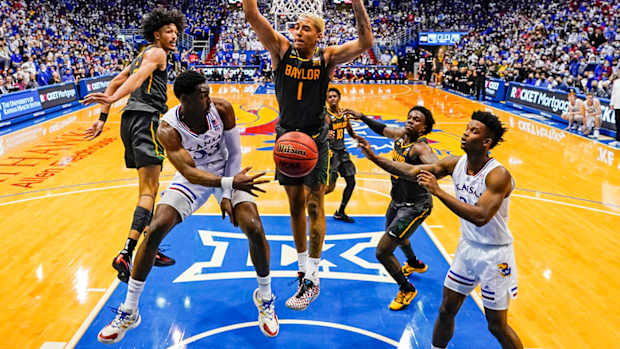 Kansas Jayhawks guard Jalen Coleman-Lands (55) passes to forward K.J. Adams (24) during the second half against the Baylor Bears at Allen Fieldhouse.