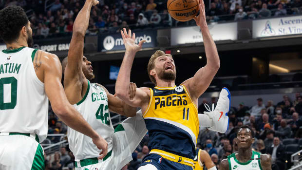 Indiana Pacers forward Domantas Sabonis (11) shoots the ball as Boston Celtics center Al Horford (42) defends in the first half at Gainbridge Fieldhouse.