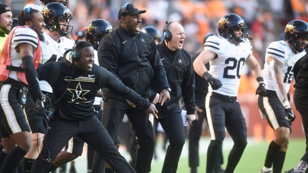 From left linebackers coach John Egorugwu, defensive ends coach Jovan Haye, and head coach Clark Lea celebrate as their defense stops Tennessee on a fourth down near the end zone in Neyland Stadium, Saturday, Nov. 27, 2021.