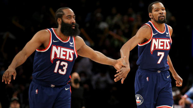 Brooklyn Nets forward Kevin Durant (7) celebrates with guard James Harden (13) after a basket against the Minnesota Timberwolves.