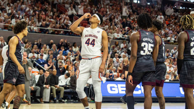 Auburn Tigers center Dylan Cardwell (44) blows a kiss to the rim after finishing and and-one play as Auburn Tigers men's basketball takes on Texas A&M Aggies at Auburn Arena in Auburn, Ala., on Saturday, Feb. 12, 2022. Auburn Tigers lead Texas A&M Aggies 33-18 at halftime.