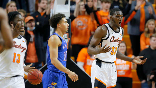 Oklahoma State Cowboys forward Moussa Cisse (33) reacts beside Kansas Jayhawks forward Jalen Wilson (10) during an NCAA basketball game between the Oklahoma State University Cowboys (OSU) and the Kansas Jayhawks at Gallagher-Iba Arena in Stillwater, Okla., Tuesday, Jan. 4, 2022. Kansas won 74-63. Osu Vs Kansas Basketball