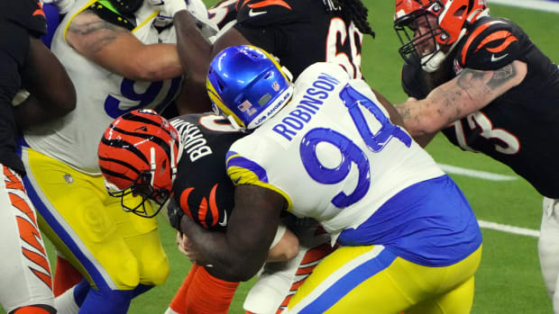 Los Angeles Rams defensive end A'Shawn Robinson (94) sacks Cincinnati Bengals quarterback Joe Burrow (9) in the fourth quarter in Super Bowl LVI at SoFi Stadium.