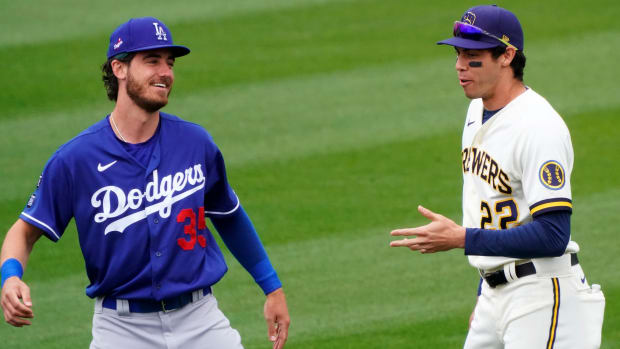 Mar 23, 2021; Phoenix, Arizona, USA; Los Angeles Dodgers center fielder Cody Bellinger (35) and Milwaukee Brewers left fielder Christian Yelich (22) talk before a spring training game at American Family Fields of Phoenix.