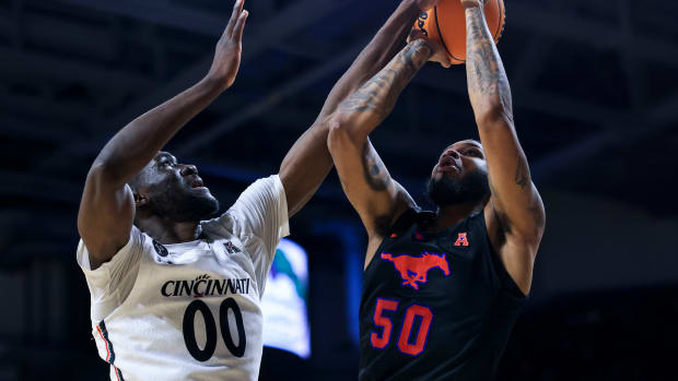 Jan 6, 2022; Cincinnati, Ohio, USA; Cincinnati Bearcats forward Abdul Ado (00) fouls as Southern Methodist Mustangs forward Marcus Weathers (50) drives to the basket in the second half at Fifth Third Arena. Mandatory Credit: Aaron Doster-USA TODAY Sports
