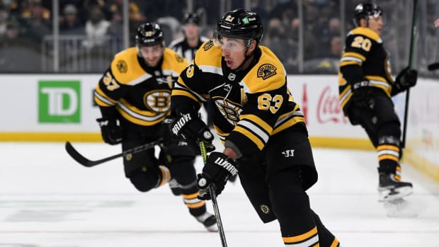Feb 1, 2022; Boston, Massachusetts, USA; Boston Bruins left wing Brad Marchand (63) skates with the puck over the blue line during the first period of a game against the Seattle Kraken at the TD Garden. Mandatory Credit: Brian Fluharty-USA TODAY Sports