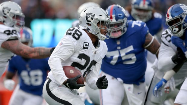 Nov 7, 2021; East Rutherford, New Jersey, USA; Las Vegas Raiders running back Josh Jacobs (28) runs the ball against New York Giants defensive tackle Danny Shelton (75) during the third quarter at MetLife Stadium.