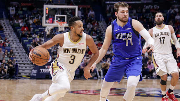 New Orleans Pelicans guard CJ McCollum (3) dribbles against Dallas Mavericks guard Luka Doncic (77) during the second half at the Smoothie King Center.