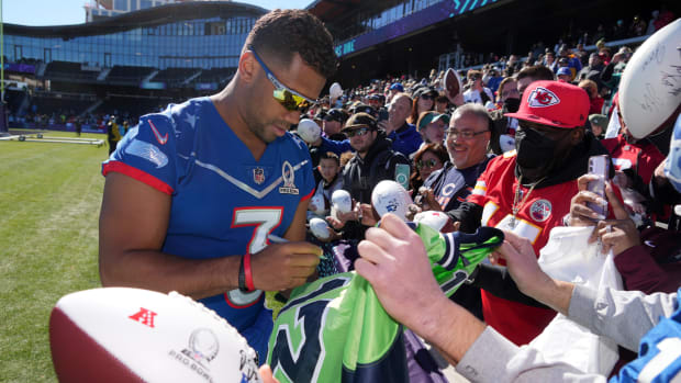 Feb 4, 2022; Las Vegas, NV, USA; Seattle Seahawks quarterback Russell Wilson (3) signs autographs for fans during NFC practice at the Las Vegas Ballpark. Mandatory Credit: Kirby Lee-USA TODAY Sports