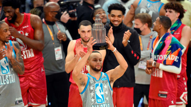 Feb 20, 2022; Cleveland, Ohio, USA; Team LeBron guard Stephen Curry (30) celebrates with a trophy for most valuable player after Team LeBron defeated Team Durant in the 2022 NBA All-Star Game at Rocket Mortgage FieldHouse. Mandatory Credit: David Richard-USA TODAY Sports