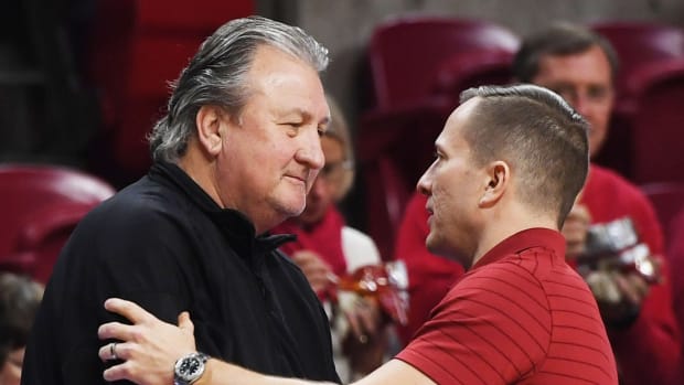 Iowa State Cyclones men's basketball head coach T.J. Otzelberger greets West Virginia Mountaineers head coach Bob Huggins before the game at Hilton Coliseum Wednesday, Feb. 23, 2022, in Ames, Iowa.