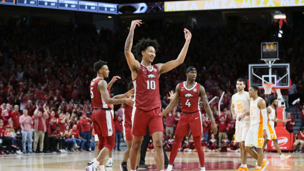 Feb 19, 2022; Fayetteville, Arkansas, USA; Arkansas Razorbacks forward Jaylin Williams (10) celebrates with guards Au'Diese Toney (5) and Davonte Davis (4) during the second half against the Tennessee Volunteers at Bud Walton Arena. Arkansas won 58-48. Mandatory Credit: Nelson Chenault-USA TODAY Sports