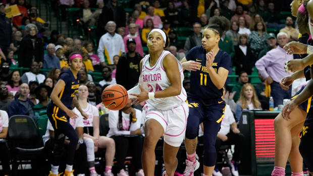 Feb 12, 2022; Waco, Texas, USA; Baylor Lady Bears guard Sarah Andrews (24) looks to score past West Virginia Mountaineers guard Ja'Naiya Quinerly (11) during the second half at Ferrell Center. Mandatory Credit: Chris Jones-USA TODAY Sports