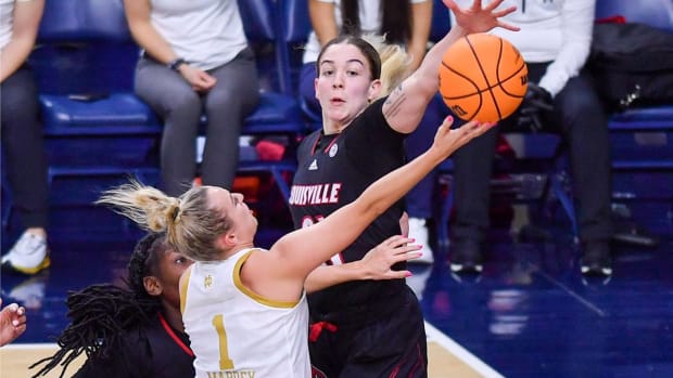 Feb 27, 2022; South Bend, Indiana, USA; Notre Dame Fighting Irish guard Dara Mabrey (1) goes up for a shot as Louisville Cardinals forward Emily Engstler (21) defends in the second half at the Purcell Pavilion. Mandatory Credit: Matt Cashore-USA TODAY Sports