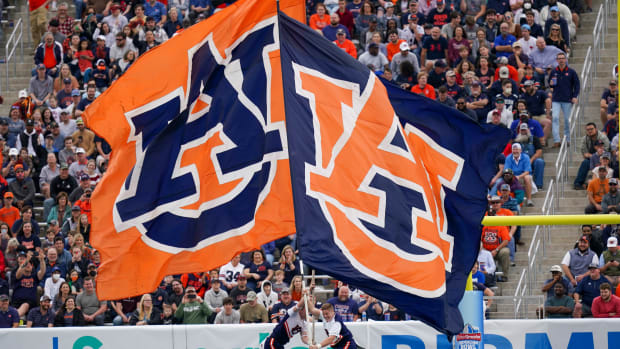 Dec 28, 2021; Birmingham, Alabama, USA; Auburn Tigers cheerleaders let the flags wave after a score against Houston Cougars during the second half of the 2021 Birmingham Bowl at Protective Stadium. Mandatory Credit: Marvin Gentry-USA TODAY Sports