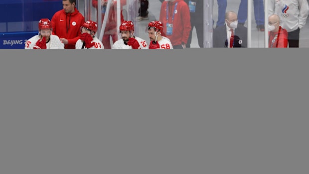 Russian Olympic Committee players stand on the ice after losing to Finland in the gold medal game.