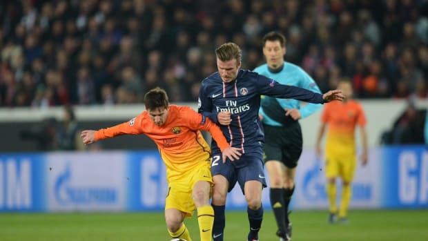 David Beckham pictured in action for PSG against Lionel Messi and Barcelona in 2013
