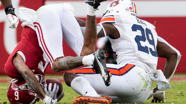 Nov 28, 2020; Tuscaloosa, Alabama, USA; Alabama wide receiver DeVonta Smith (6) is put on his head by Auburn defensive lineman Derick Hall (29) at Bryant-Denny Stadium in the Iron Bowl. Mandatory Credit: Mickey Welsh/The Montgomery Advertiser via USA TODAY Sports