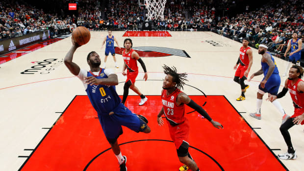 Denver Nuggets power forward JaMychal Green (0) shoots the ball past Portland Trail Blazers shooting guard Ben McLemore (23) during the second half at Moda Center.