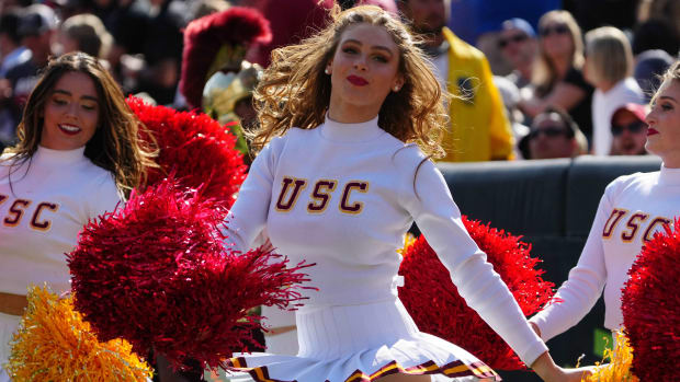 USC Trojans cheerleaders at a Pac-12 college football game.