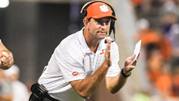 Clemson head coach Dabo Swinney celebrating a play from the sideline during a college football game in the ACC.