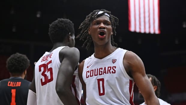 Mar 3, 2022; Pullman, Washington, USA; Washington State Cougars forward Mouhamed Gueye (35) and forward Efe Abogidi (0) celebrate after a play against the Oregon State Beavers in the second half at Friel Court at Beasley Coliseum. Washington St. won 71-67. Mandatory Credit: James Snook-USA TODAY Sports