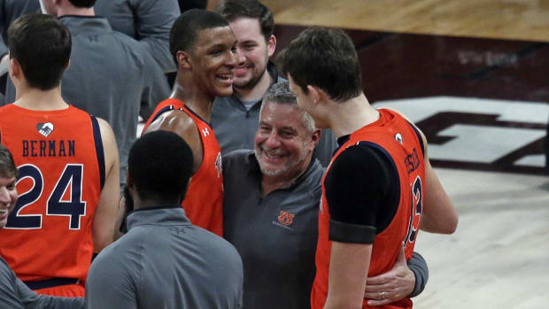 Mar 2, 2022; Starkville, Mississippi, USA; Auburn Tigers head coach Bruce Pearl (center) reacts with forward Jabari Smith (10) and forward Walker Kessler (13) after defeating the Mississippi State Bulldogs at Humphrey Coliseum. Mandatory Credit: Petre Thomas-USA TODAY Sports