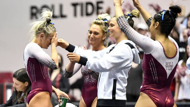 Alabama gymnast Lexi Graber (left) reacts to her score of 9.975 in her final floor exercise in Coleman Coliseum Friday