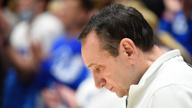 Duke Blue Devils head coach Mike Krzyzewski bows his head during the national anthem prior to a game against the North Carolina Tar Heels at Cameron Indoor Stadium.
