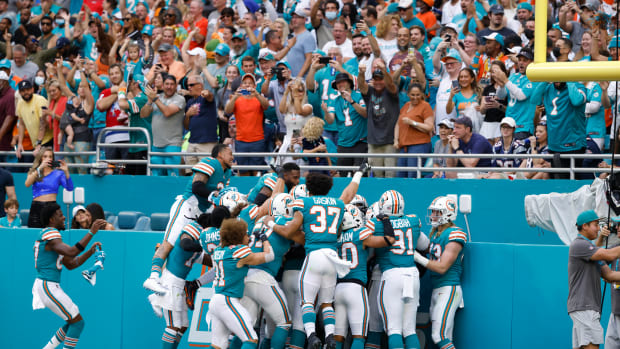 Jan 9, 2022; Miami Gardens, Florida, USA; The Miami Dolphins celebrate after cornerback Xavien Howard (25) scored a touchdown after intercepting the ball against the New England Patriots during the first quarter at Hard Rock Stadium. Mandatory Credit: Rhona Wise-USA TODAY Sports
