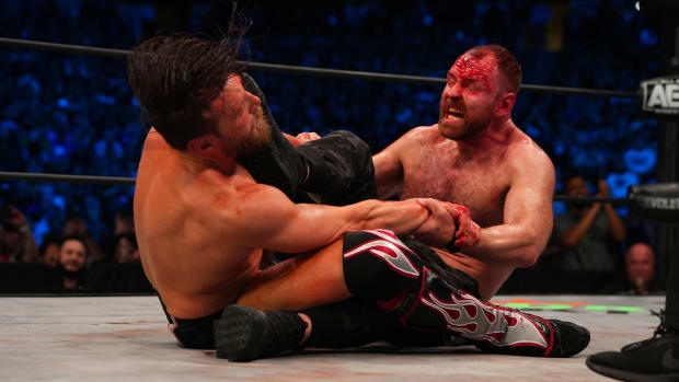 A bloody Jon Moxley kicks Bryan Danielson in their match at AEW Revolution