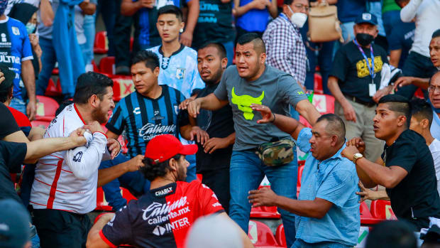 Fans of Queretaro and Atlas clash during a Mexican soccer league match at the Corregidora stadium, in Queretaro, Mexico.