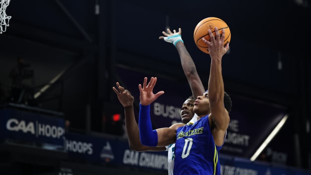 Delaware Fightin Blue Hens guard Jameer Nelson Jr. (0) goes to the basket against North Carolina-Wilmington Seahawks forward Amari Kelly (23) during the first half of the Colonial Conference Championship game at Entertainment and Sports Arena.
