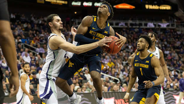 Mar 9, 2022; Kansas City, MO, USA; Kansas State Wildcats forward Ismael Massoud (25) forces a jump ball on a shot by West Virginia Mountaineers guard Malik Curry (10) in the second half at T-Mobile Center. Mandatory Credit: Amy Kontras-USA TODAY Sports