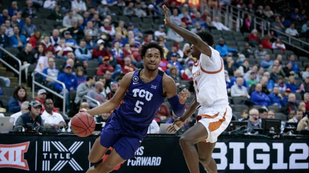 Mar 10, 2022; Kansas City, MO, USA; TCU Horned Frogs forward Chuck O'Bannon Jr. (5) drives around Texas Longhorns guard Andrew Jones (1) during the second half at T-Mobile Center. Mandatory Credit: William Purnell-USA TODAY Sports