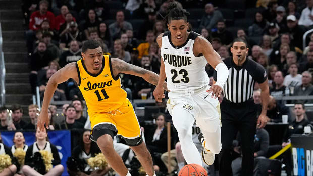 Iowa’s Tony Perkins and Purdue’s Jaden Ivey go for a loose ball