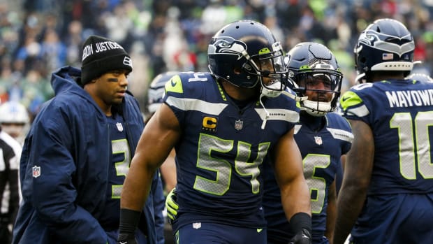 Seattle Seahawks middle linebacker Bobby Wagner (54) is assisted to the sideline by free safety Quandre Diggs (6) following an injury against the Detroit Lions during the first quarter at Lumen Field. Seattle Seahawks quarterback Russell Wilson (3) follows behind Wagner and Diggs.