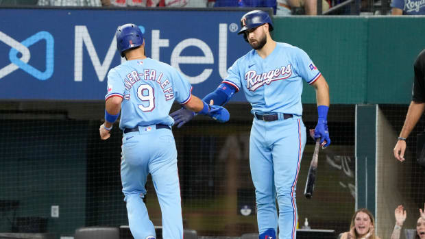 Jun 27, 2021; Arlington, Texas, USA; Texas Rangers shortstop Isiah Kiner-Falefa (9) is congratulated by right fielder Joey Gallo (13) after scoring against the Kansas City Royals during the first inning of a baseball game at Globe Life Field. Mandatory Credit: Jim Cowsert-USA TODAY Sports