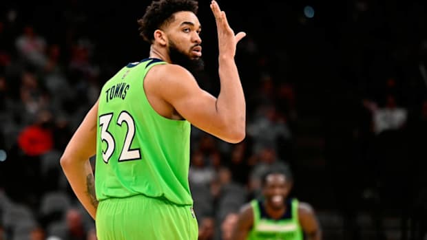 Minnesota Timberwolves’ Karl-Anthony Towns celebrates a 3-point basket late in the second half of an NBA basketball game against the San Antonio Spurs on Monday, March 14, 2022, in San Antonio. (AP Photo/Darren Abate)