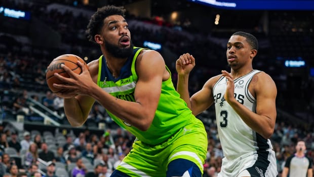 Minnesota Timberwolves center Karl-Anthony Towns (32) backs in against San Antonio Spurs forward Keldon Johnson.