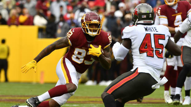 Nov 14, 2021; Landover, Maryland, USA; Washington Football Team tight end Ricky Seals-Jones (83) runs after a catch as Tampa Bay Buccaneers linebacker Devin White (45) defends during the first half at FedExField.