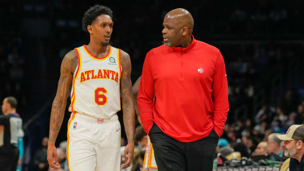 Mar 16, 2022; Charlotte, North Carolina, USA; Atlanta Hawks head coach Nate McMillan head coach Nate McMillan talks with guard Lou Williams (6) during the second quarter against the Charlotte Hornets at the Spectrum Center.