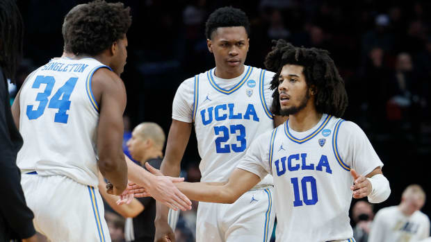 Mar 17, 2022; Portland, OR, USA; UCLA Bruins guard Tyger Campbell (10) is congratulated against the Akron Zips during the second half during the first round of the 2022 NCAA Tournament at Moda Center.