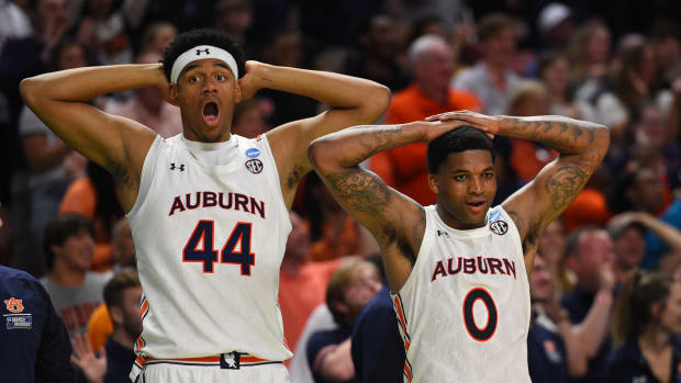 Mar 18, 2022; Greenville, SC, USA; Auburn Tigers center Dylan Cardwell (44) and Auburn Tigers guard K.D. Johnson (0) react against the Jackson State Tigers during the first round of the 2022 NCAA Tournament at Bon Secours Wellness Arena. Mandatory Credit: Bob Donnan-USA TODAY Sports