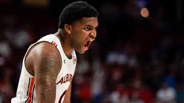 Auburn’s K.D. Johnson, center, reacts after scoring during the first half of a college basketball game against Jacksonville State in the first round of the NCAA tournament, Friday, March 18, 2022, in Greenville, S.C.