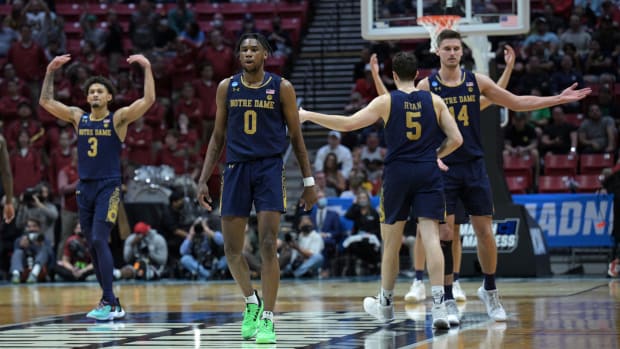 Notre Dame men’s basketball players celebrate in the second half of a game.
