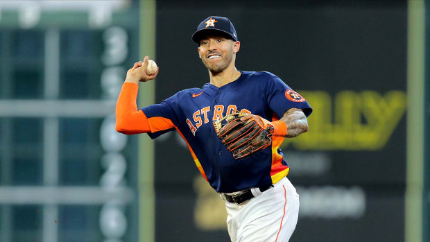Sep 12, 2021; Houston, Texas, USA; Houston Astros shortstop Carlos Correa (1) throws a fielded ball to first base attempting to completed a double play against the Los Angeles Angels during the eighth inning at Minute Maid Park.